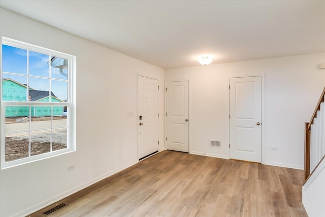 spare room with light hardwood / wood-style floors