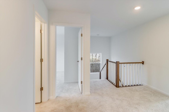 hall with light colored carpet