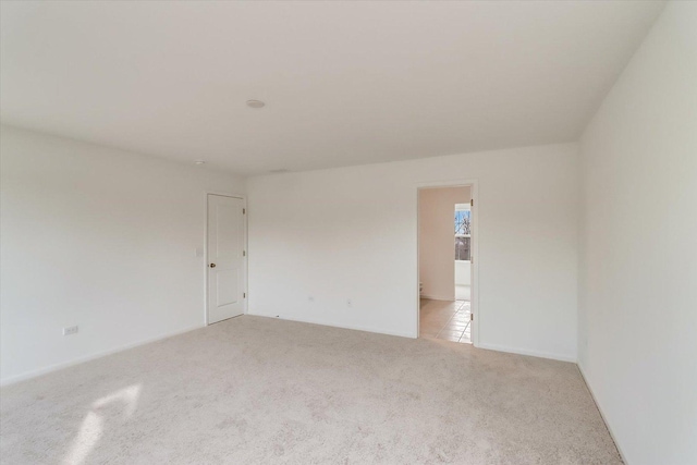 spare room with light colored carpet