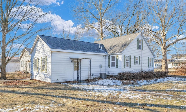 view of snow covered rear of property