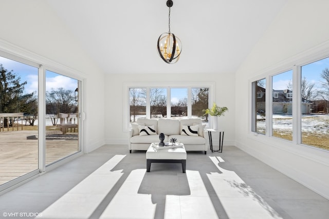 sunroom / solarium with vaulted ceiling and a notable chandelier