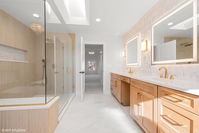 bathroom featuring a skylight, vanity, decorative backsplash, and walk in shower