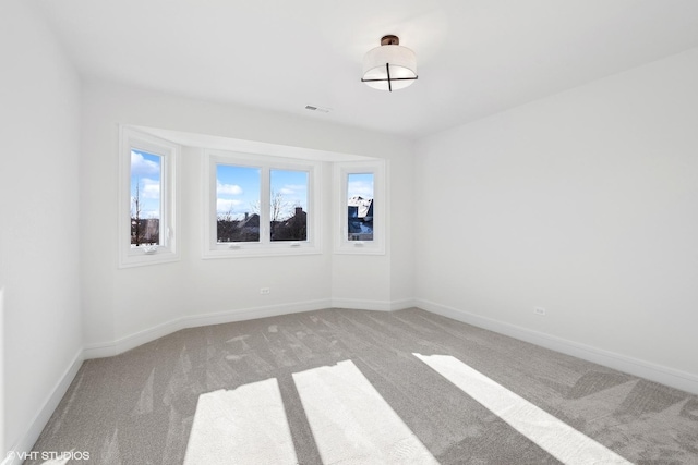 unfurnished room featuring light colored carpet