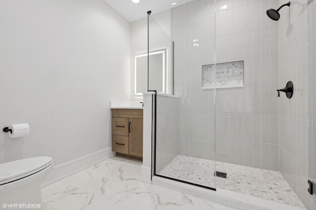 bathroom with vanity, a shower with shower door, and toilet