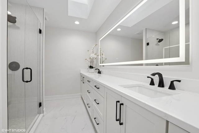 bathroom featuring vanity, a skylight, and walk in shower