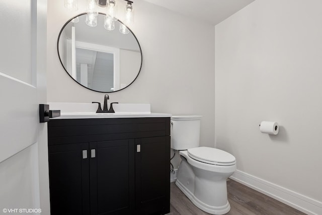 bathroom featuring hardwood / wood-style flooring, vanity, and toilet