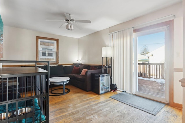 living room featuring hardwood / wood-style floors and ceiling fan