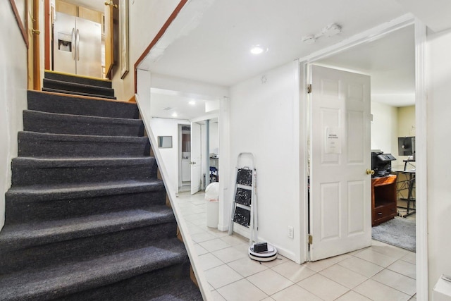 stairs featuring tile patterned floors