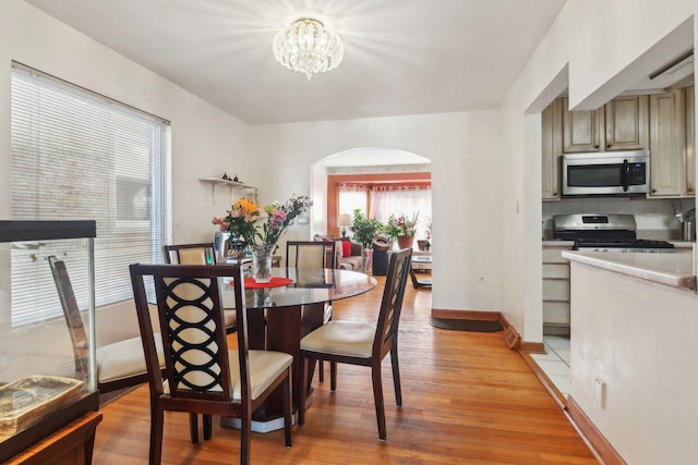 dining area featuring a chandelier and light hardwood / wood-style flooring