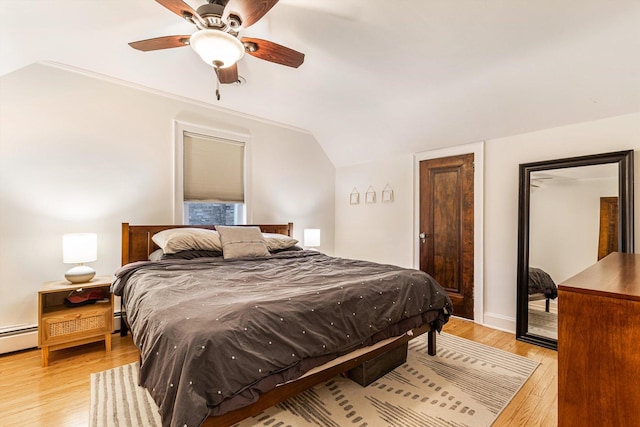 bedroom with vaulted ceiling, ceiling fan, and light hardwood / wood-style floors