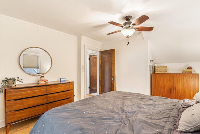 bedroom with ceiling fan, ornamental molding, and light hardwood / wood-style floors