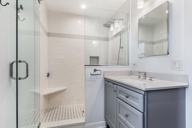 bathroom featuring vanity and a shower with shower door