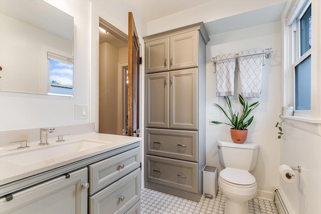 bathroom with vanity, a baseboard radiator, and toilet