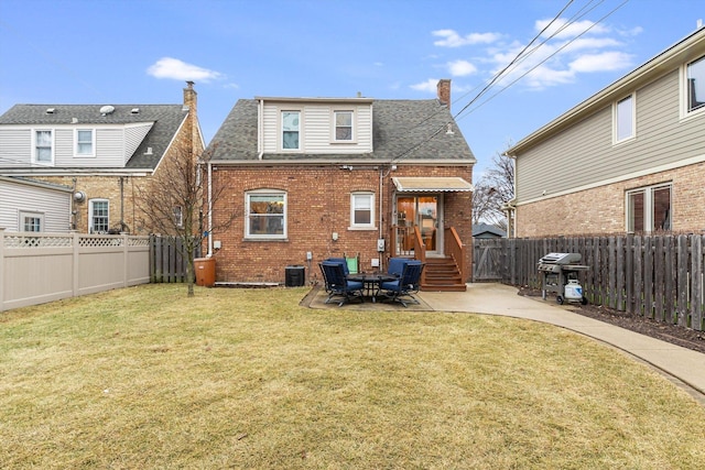 rear view of property with a yard and a patio area