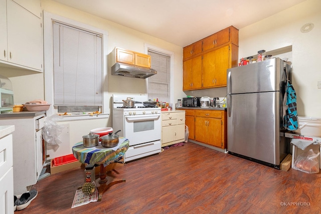 kitchen with stainless steel refrigerator, white gas stove, and dark wood-type flooring