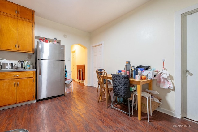 kitchen with dark hardwood / wood-style floors and stainless steel refrigerator