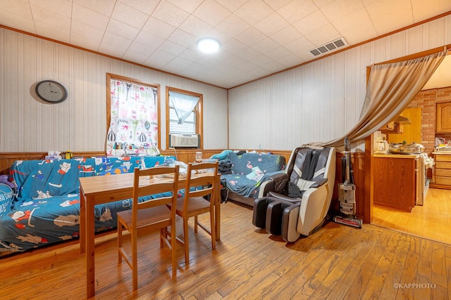 dining space with light hardwood / wood-style flooring and cooling unit