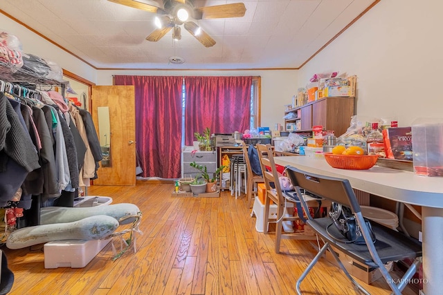 interior space featuring ceiling fan, crown molding, and light wood-type flooring