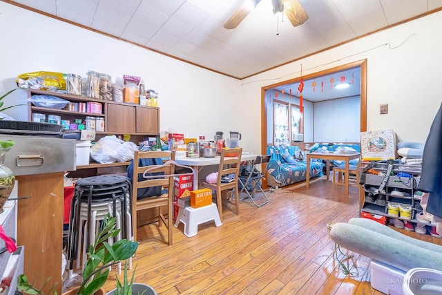 interior space featuring ceiling fan, light hardwood / wood-style flooring, and crown molding