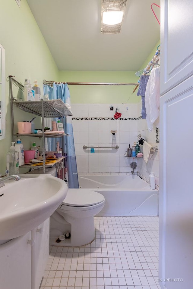 bathroom with tile patterned flooring, toilet, and shower / bath combo with shower curtain