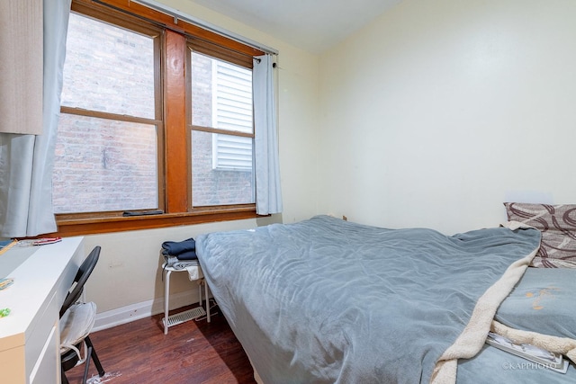 bedroom with dark hardwood / wood-style floors