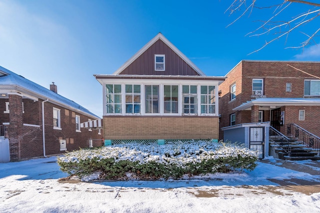 view of front of house featuring a sunroom