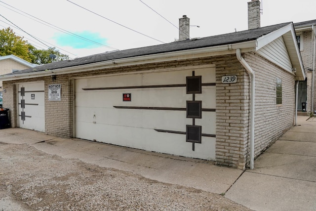 view of property exterior with an outbuilding and a garage