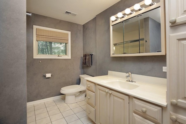 bathroom with tile patterned flooring, vanity, and toilet