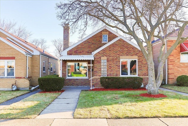 bungalow-style home featuring a front lawn