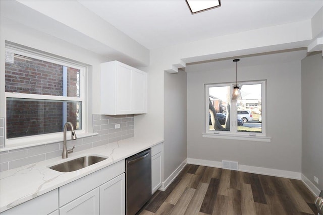 kitchen featuring white cabinets, light stone counters, sink, pendant lighting, and dishwasher