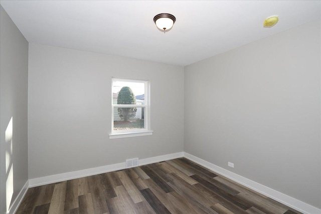 spare room with dark hardwood / wood-style flooring