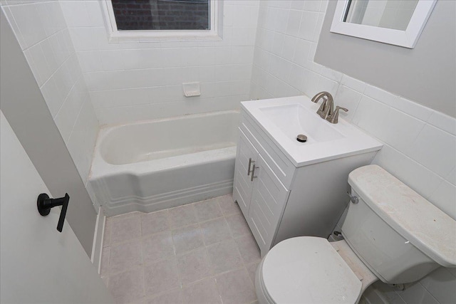 bathroom with vanity, tile walls, and toilet