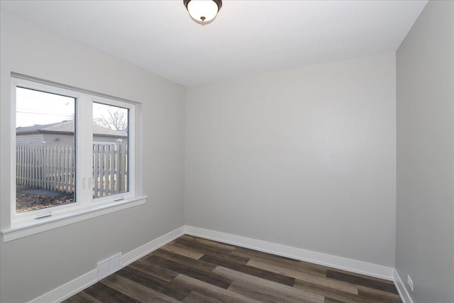 unfurnished room featuring dark hardwood / wood-style floors