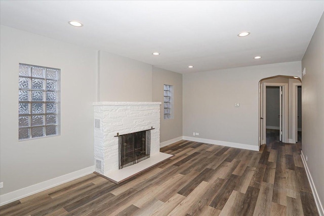 unfurnished living room with dark hardwood / wood-style floors and a fireplace