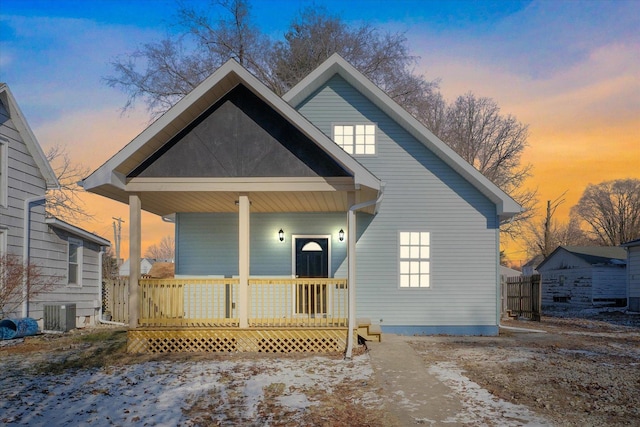 bungalow with central air condition unit and a porch