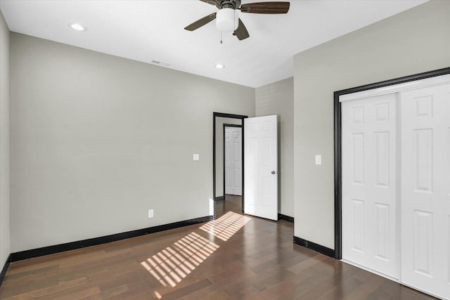 unfurnished bedroom with a closet, ceiling fan, and dark hardwood / wood-style floors