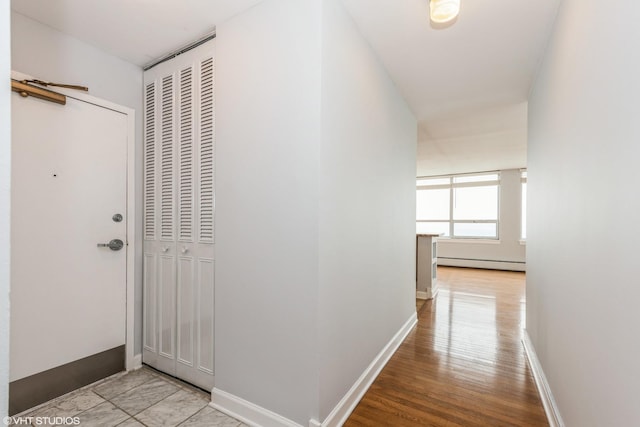 corridor featuring light hardwood / wood-style flooring and a baseboard radiator