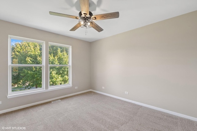 empty room featuring carpet and ceiling fan