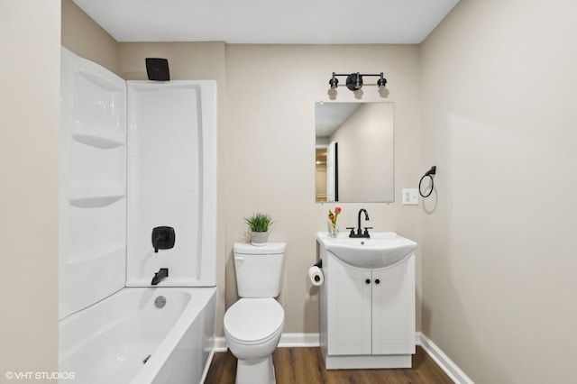 full bathroom featuring hardwood / wood-style floors, vanity, toilet, and bathing tub / shower combination