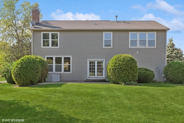 rear view of house with a yard