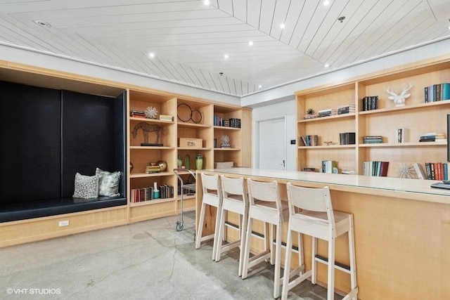 bar featuring built in features and wooden ceiling