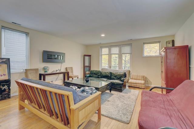 living room featuring light wood-type flooring and french doors