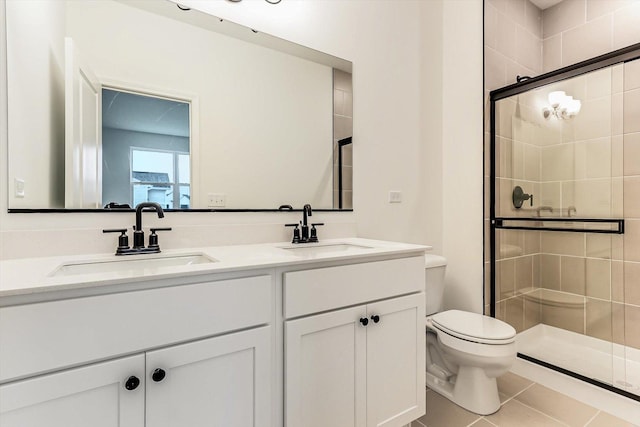 bathroom with tile patterned flooring, vanity, toilet, and walk in shower