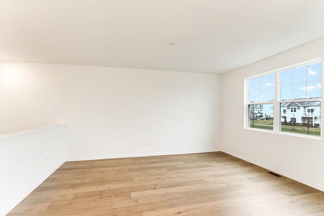 spare room with light hardwood / wood-style floors