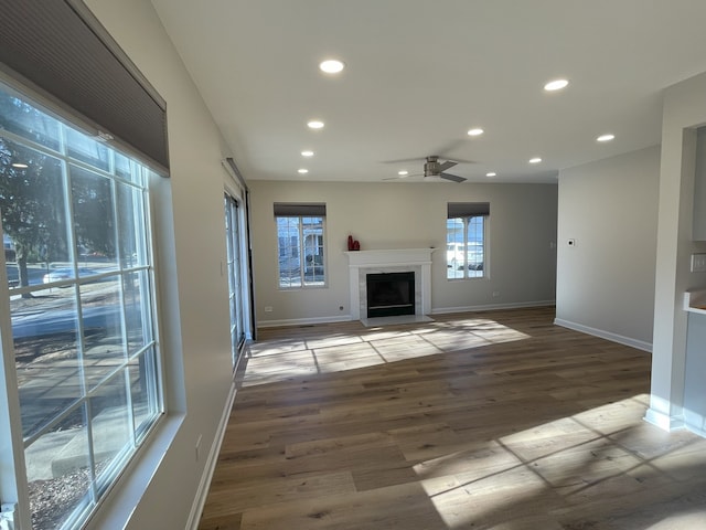 unfurnished living room with hardwood / wood-style floors and ceiling fan