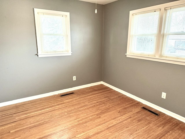 empty room with light hardwood / wood-style floors