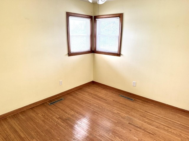 unfurnished room featuring hardwood / wood-style floors