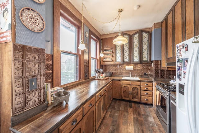 kitchen with dark wood-style floors, white refrigerator with ice dispenser, gas stove, brown cabinets, and wood counters