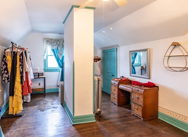 bonus room featuring lofted ceiling, a ceiling fan, baseboards, and dark wood-type flooring