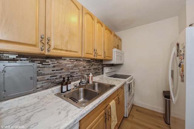 kitchen featuring light brown cabinetry, white appliances, backsplash, and sink